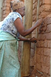 Adobe bricks applying plaster